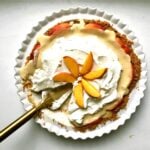 Peachy custard pie missing a slice.
