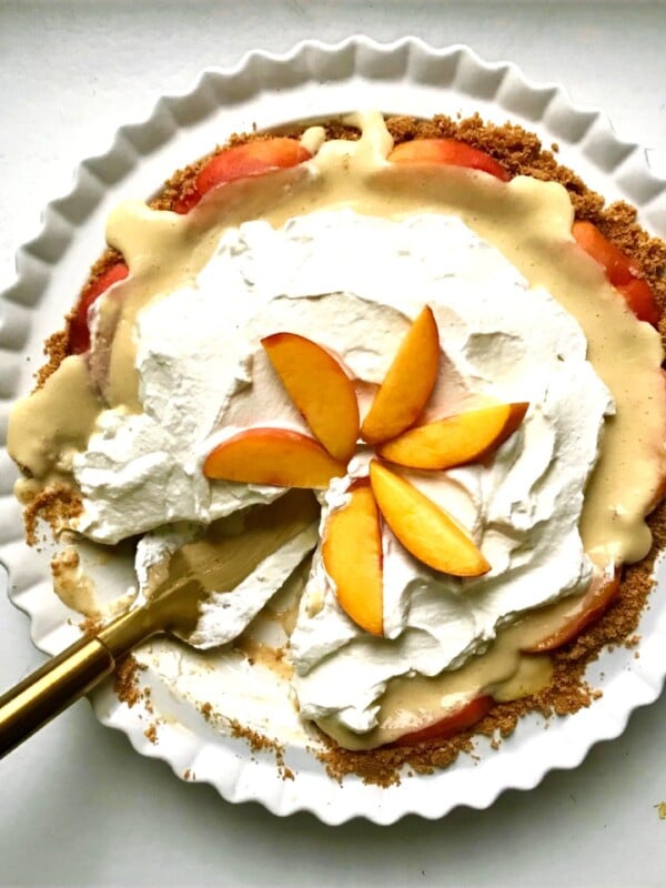 Peachy custard pie missing a slice.