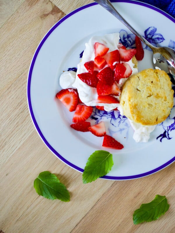 Strawberry biscuit shortcake on a blue and white floral plate.