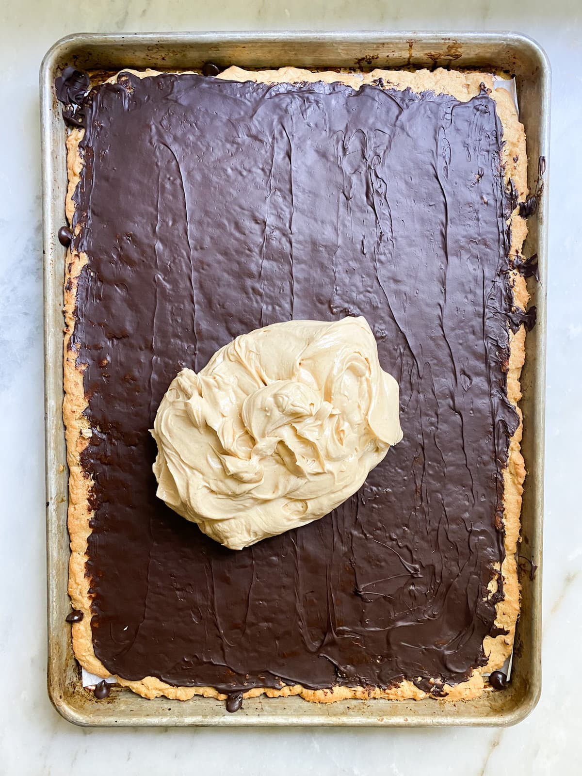 process for peanut butter bars- adding the peanut buttercream layer.