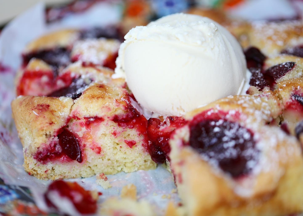 Close up of plum torte with ice cream.