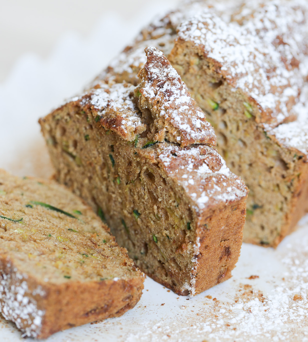 Partially-sliced loaf of cinnamon sugar zucchini bread.
