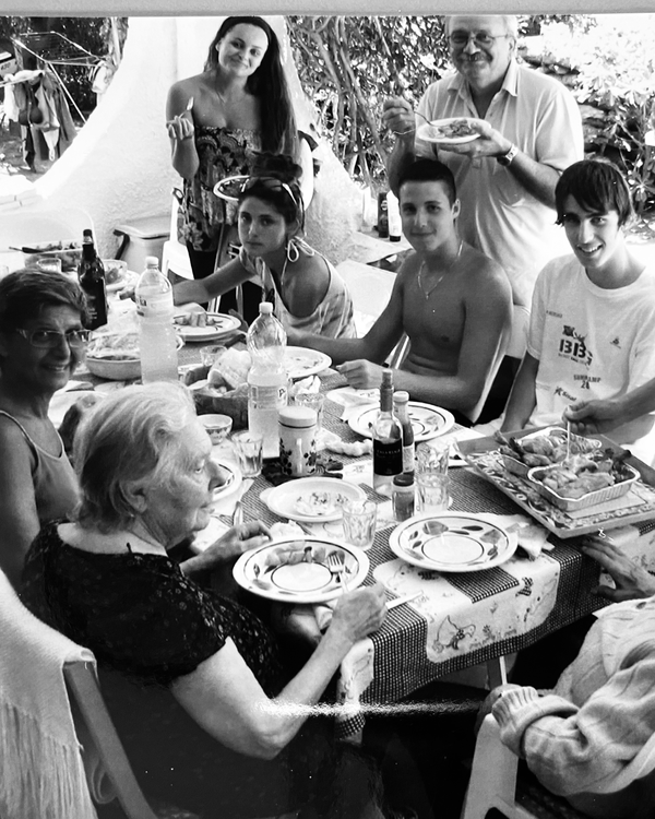 Black and white photo of people around a table.