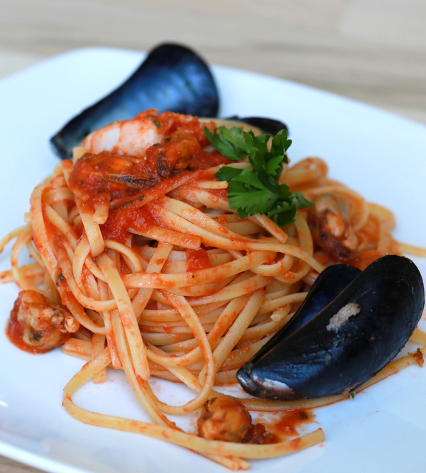 seafood pasta with red sauce on a plate