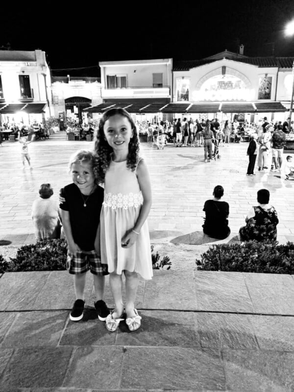 Black and white photo of two smiling children.