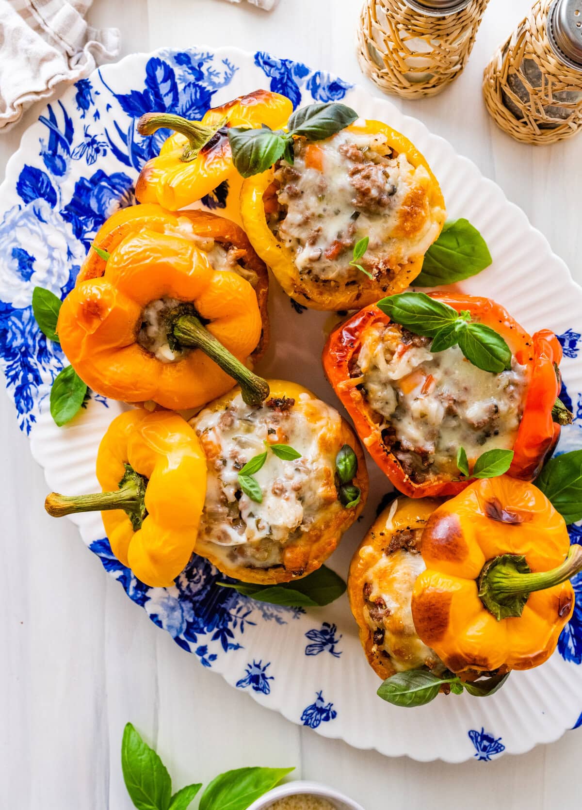 Italian stuffed peppers on an oval blue and white platter.