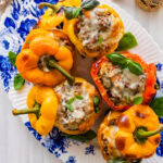 Italian stuffed bell peppers on a blue and white platter.
