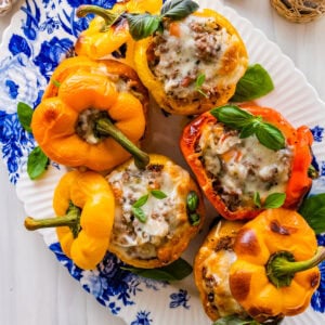 Italian stuffed bell peppers on a blue and white platter.