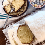 A slice of easter coconut cake on a plate.