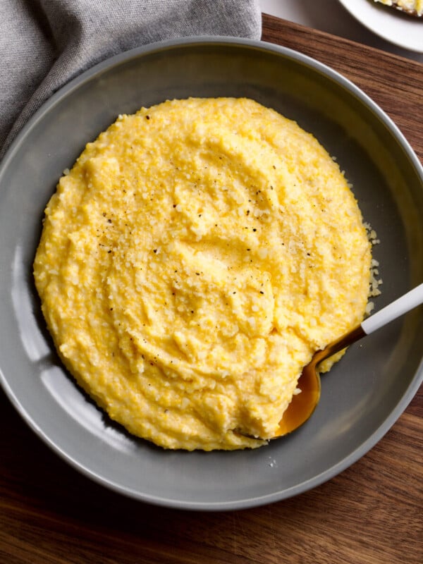 creamy polenta in a large grey bowl.