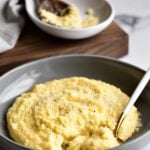 bowl of creamy polenta with spoon in it.