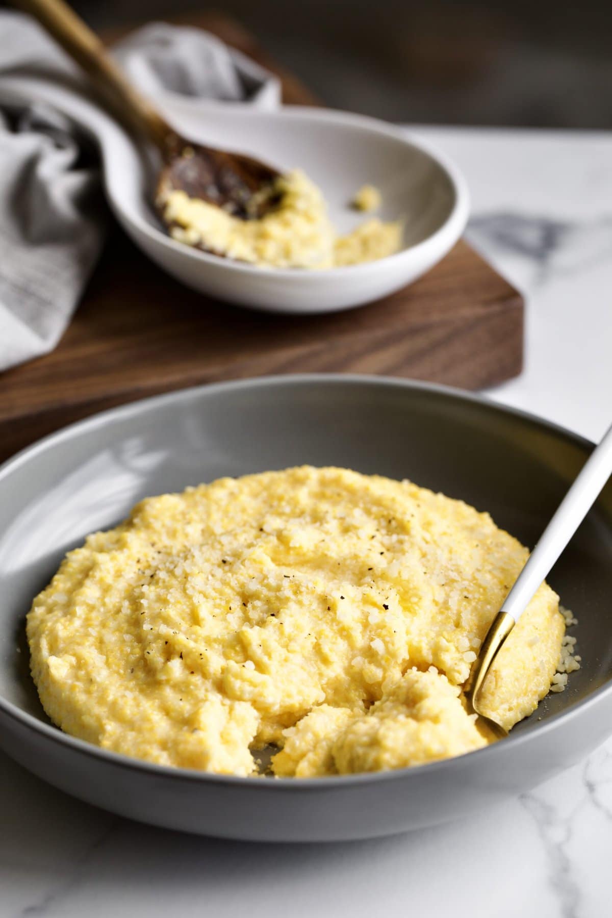 bowl of creamy polenta with spoon in it.