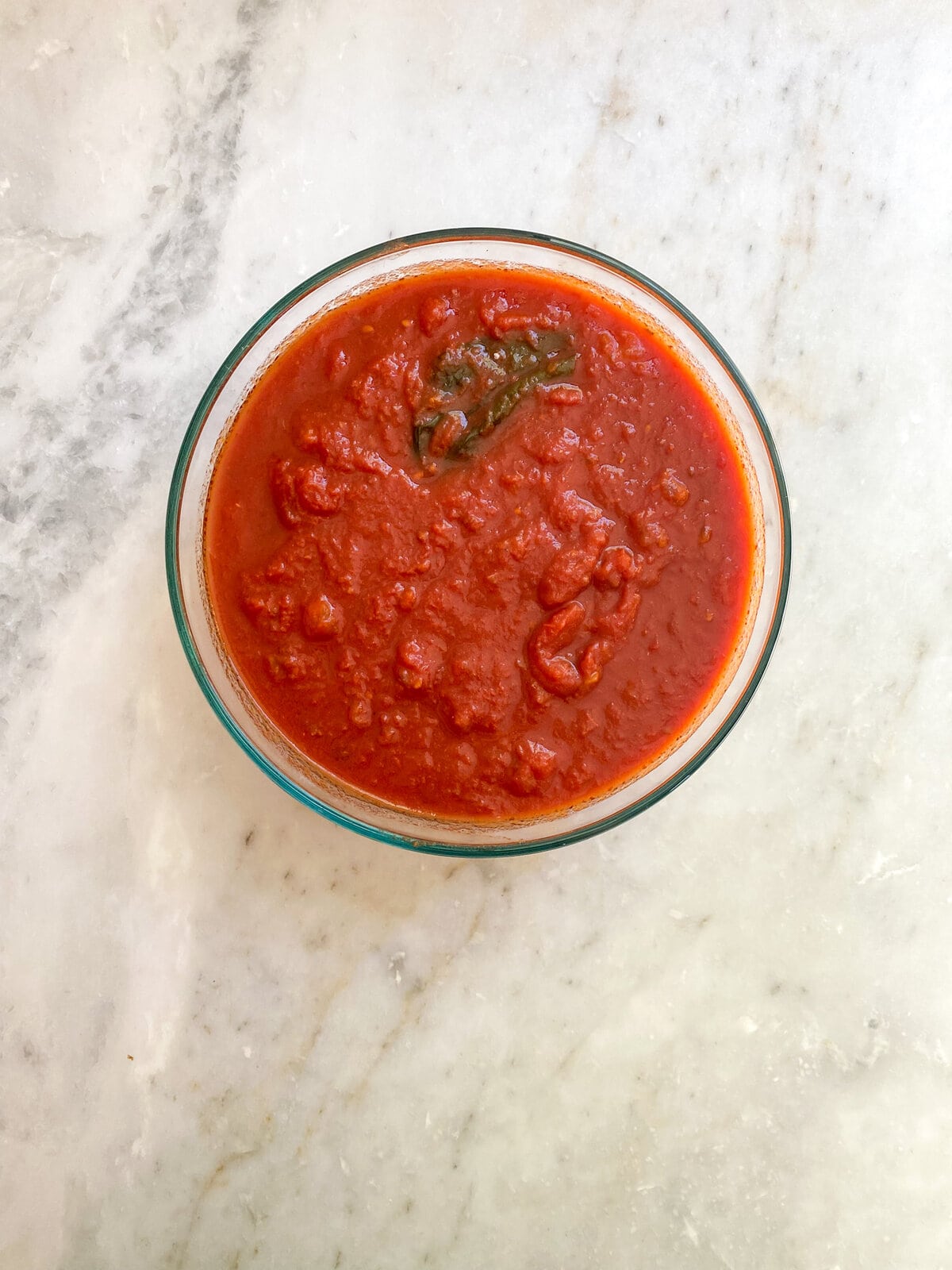 Small glass bowl of tomato sauce.