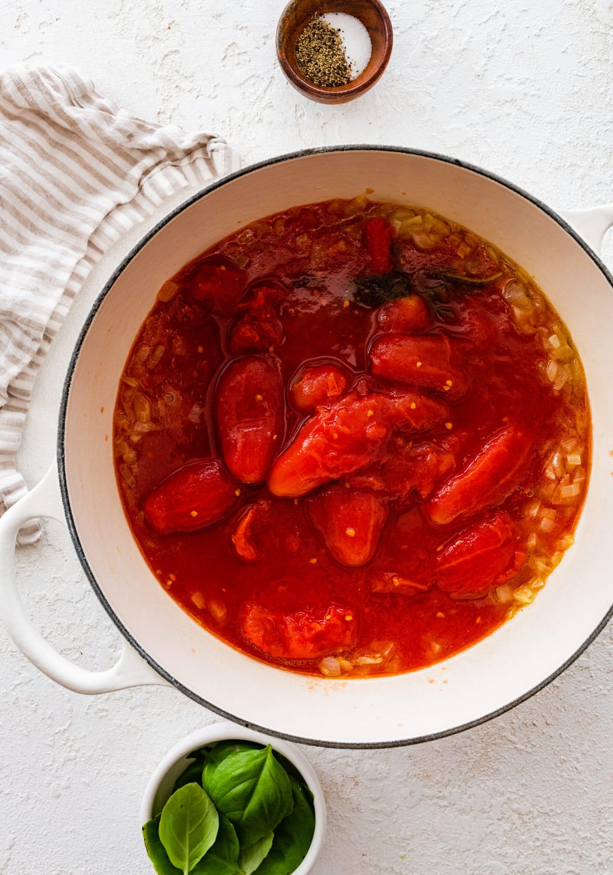 how to make sugo al pomodoro step-by-step photos: adding whole canned tomatoes to the pot with onions.