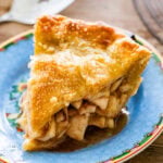 A slice of apple pie on a plate.