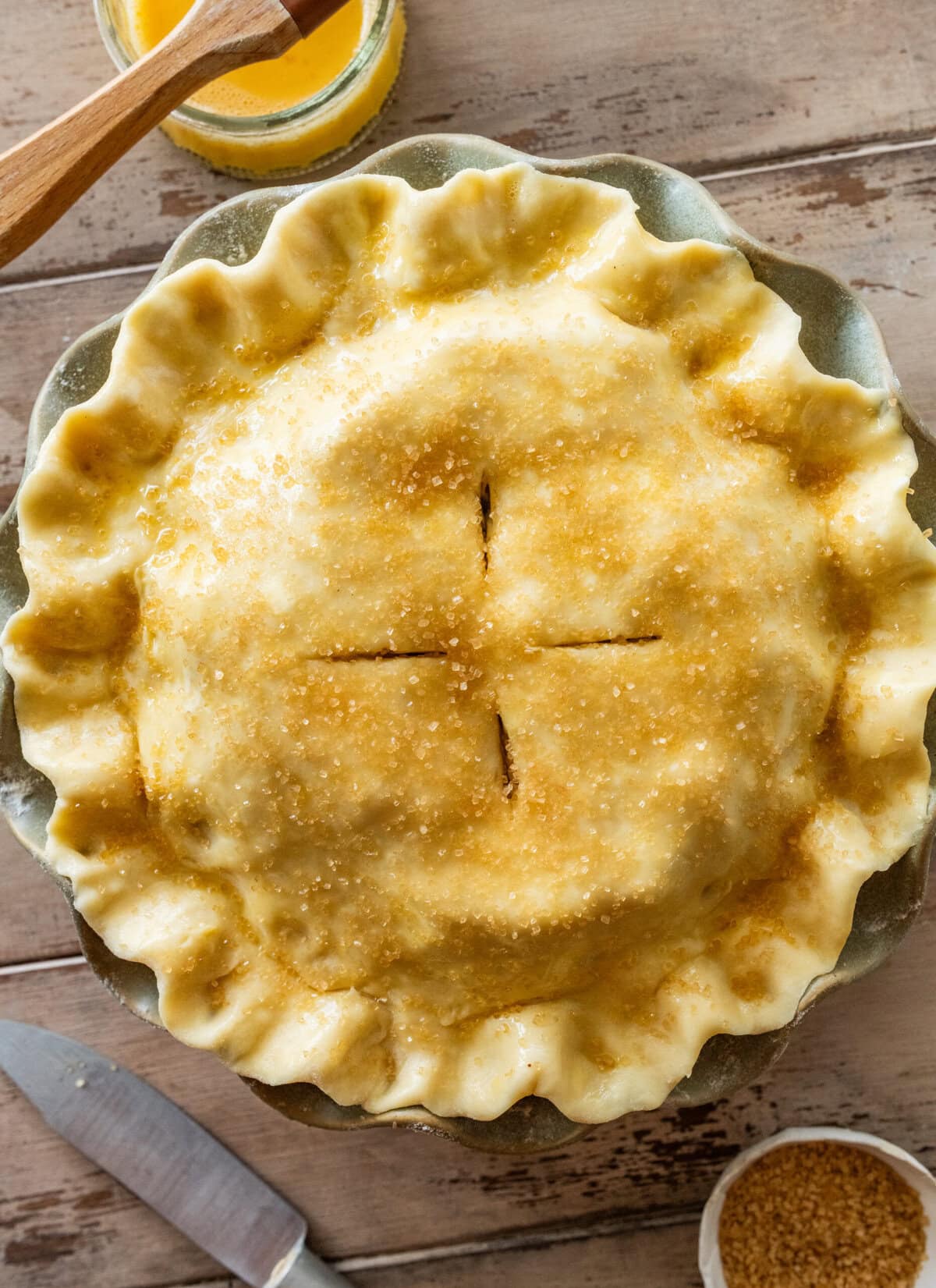 An apple pie in a pie dish before placing in the oven.