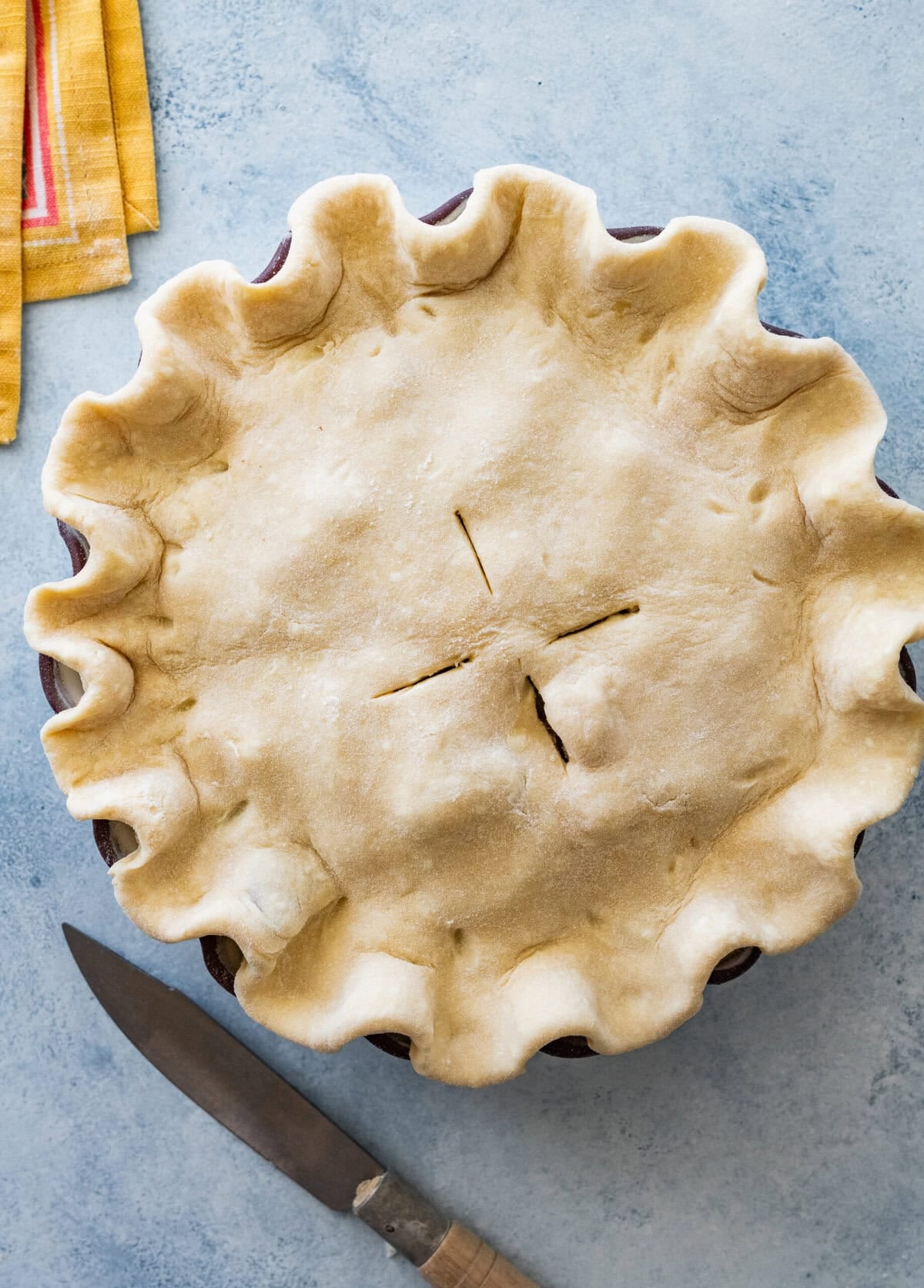 the rhubarb pie before baking it, with a knife nearby.