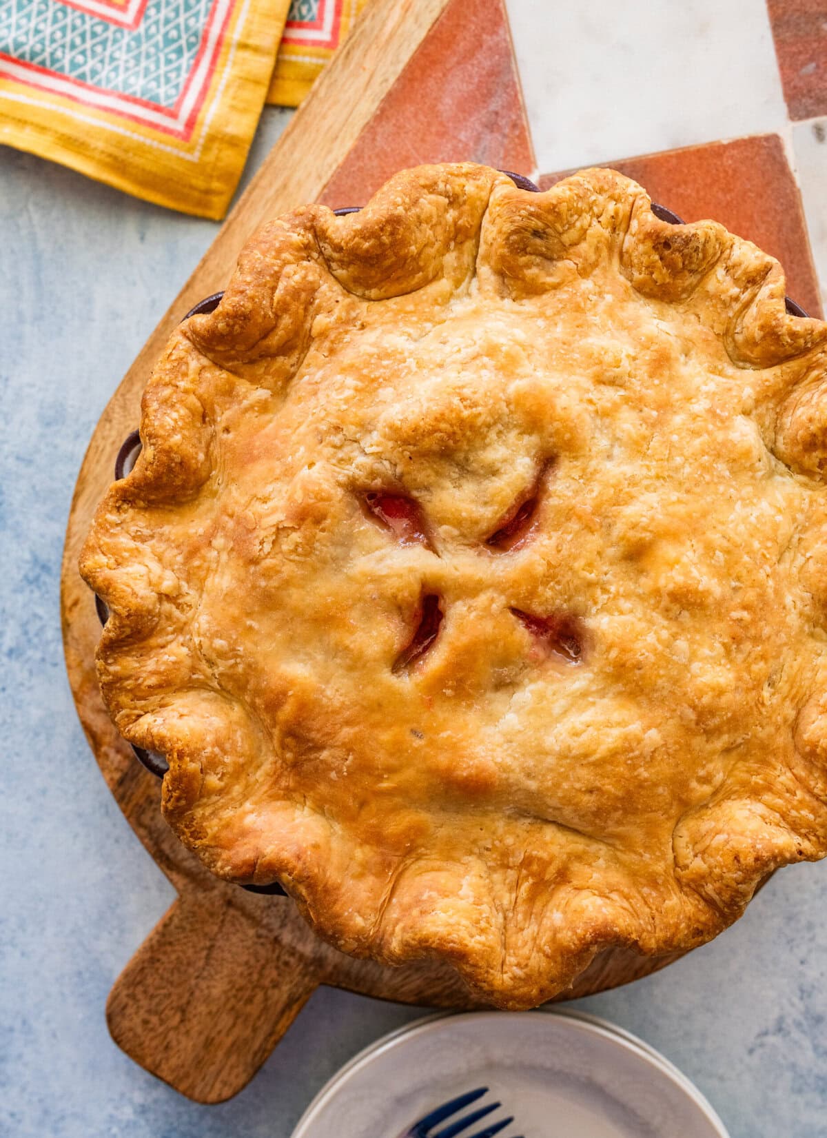 rhubarb pie after baking, with more ingredients nearby.
