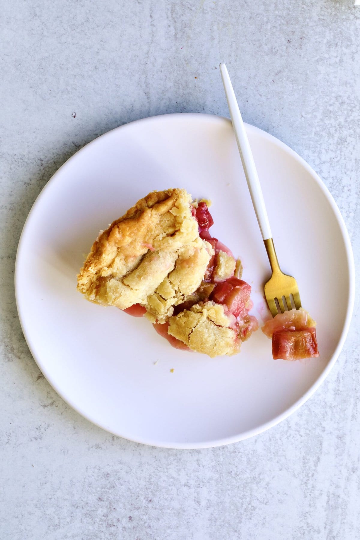 slice of rhubarb pie on a plate with fork. 