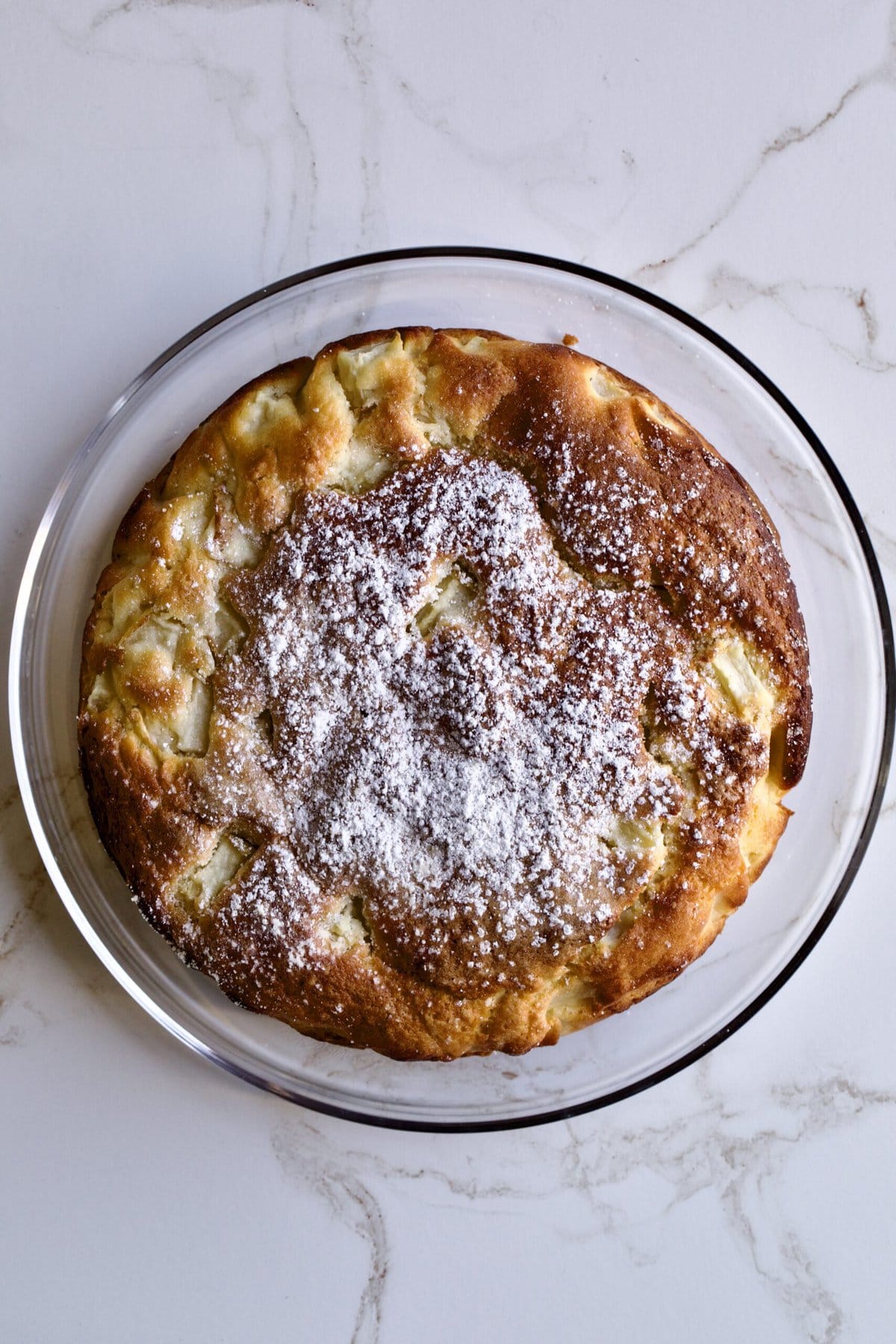 Italian pear cake on a glass dish.