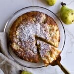 Spatula removing a slice from an Italian pear cake.