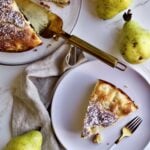 Italian pear cake recipe. Slice of cake on a plate with fresh pears as the background.