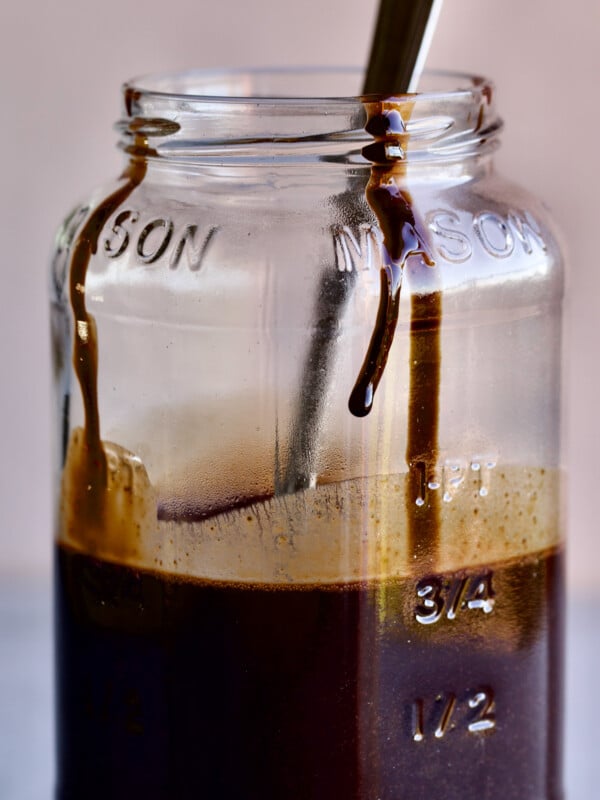 chocolate syrup in Mason jar with drip. Spoon inside jar.