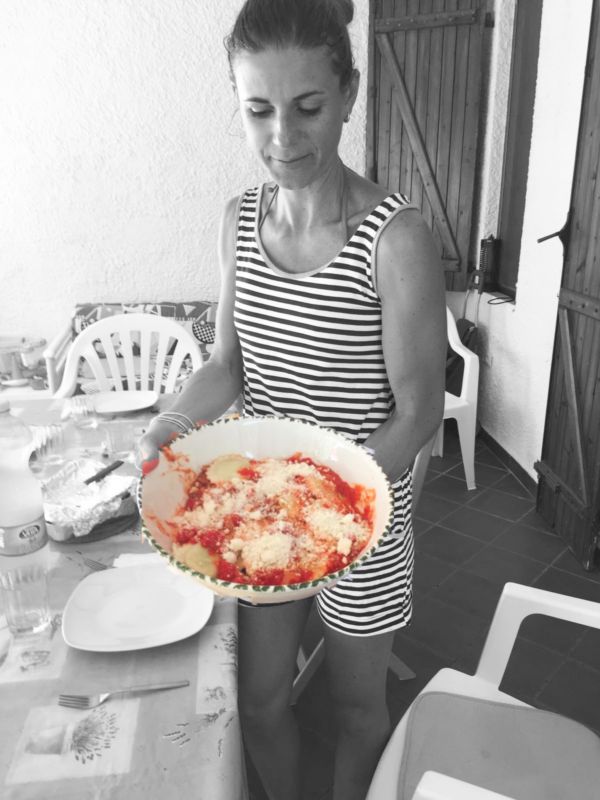 italian girl holding plate with pasta