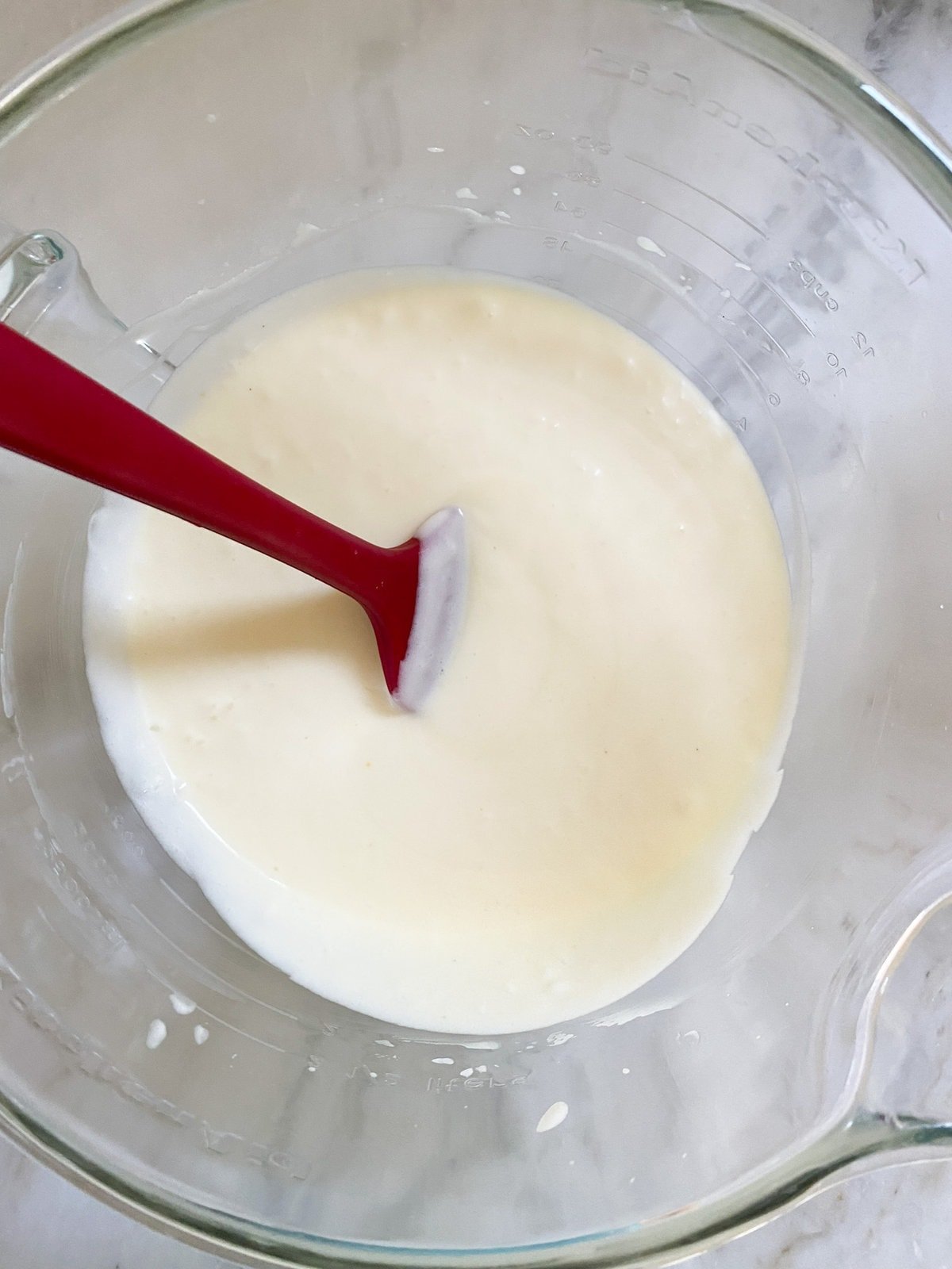 How to make Italian pear cake recipe step-by-step. Adding the yogurt and butter to eggs and sugar. mixture.