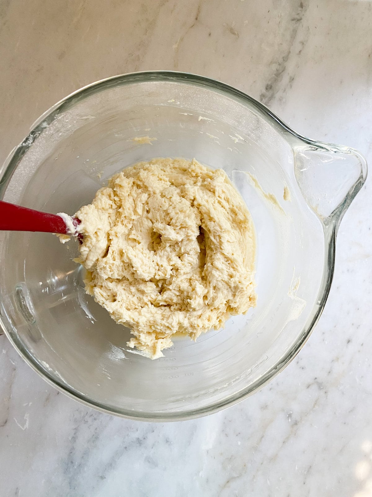 How to make Italian pear cake recipe step-by-step. Adding the yogurt and butter to eggs and sugar. Finished cake batter mixture.