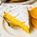 slice of cake on a plate with a fork ready to eat.