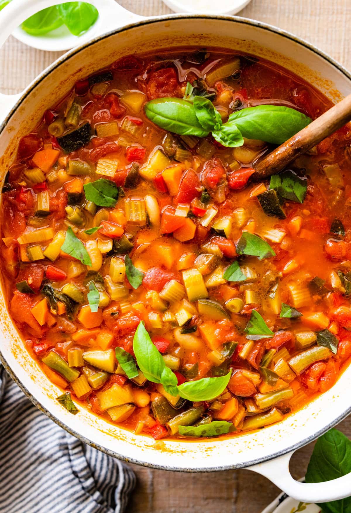 cooked minestrone soup stir with a wooden spoon.