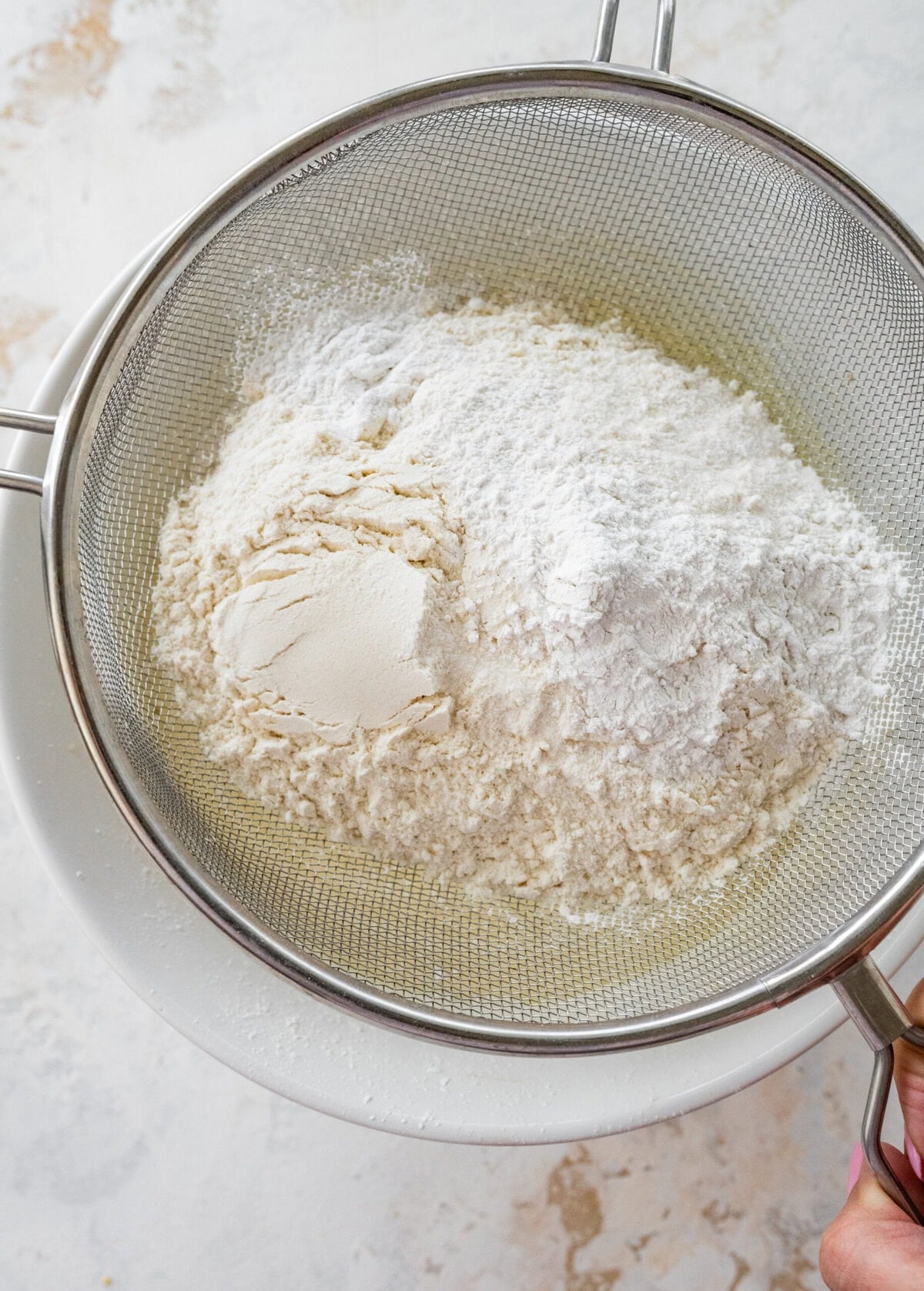 Flour in a mesh strainer. 