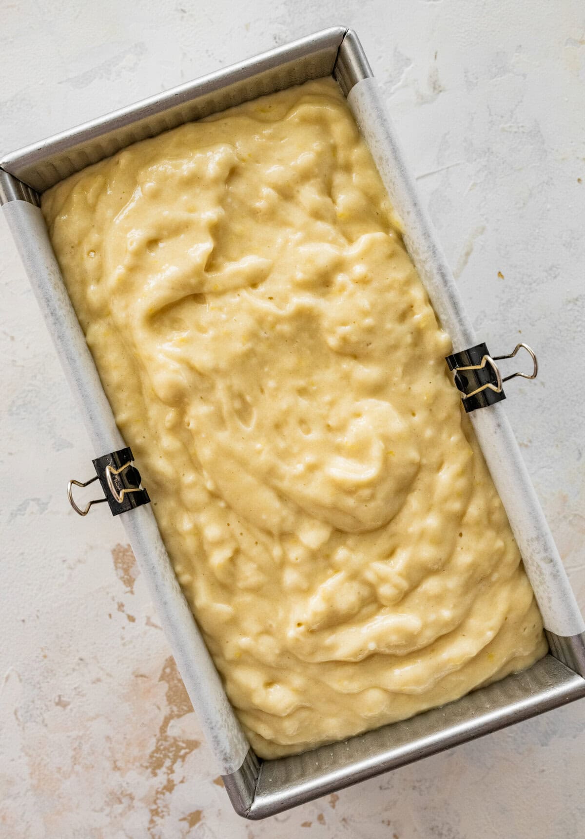 Lemon loaf cake batter poured into the pan. 