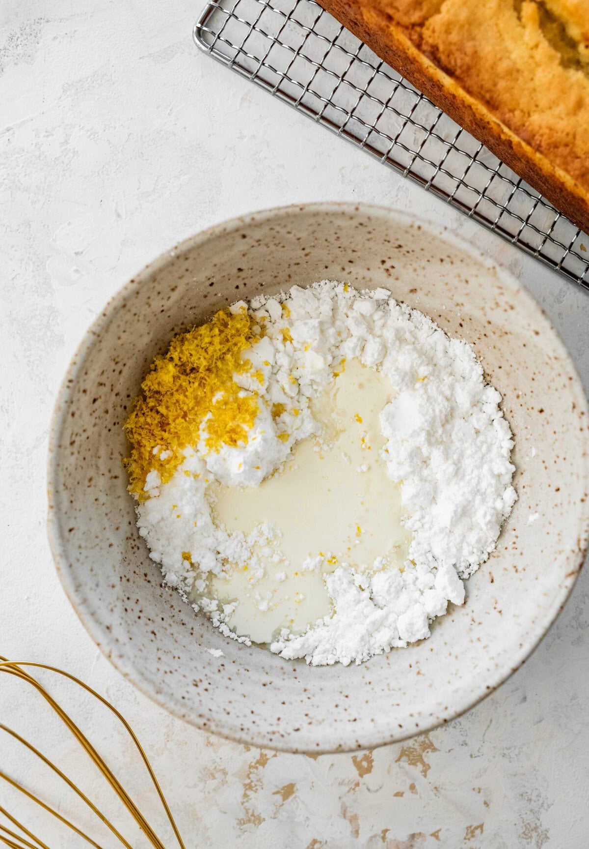 Icing ingredients added to a bowl. 