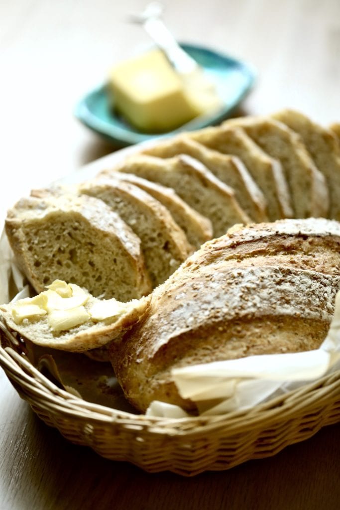 Sliced and unsliced bread in a basket.