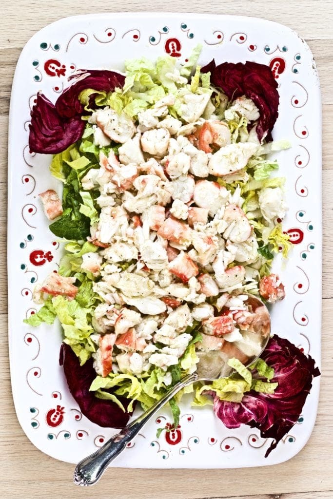 platted final dish with crab and salad on a large platter