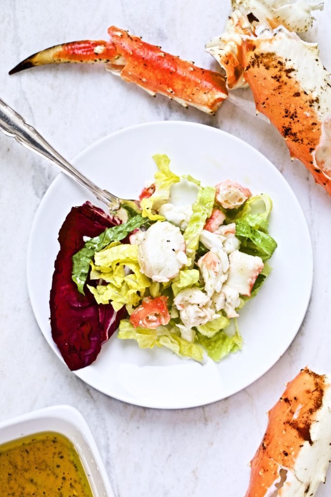 big chunks of crab meat on a plate with salad