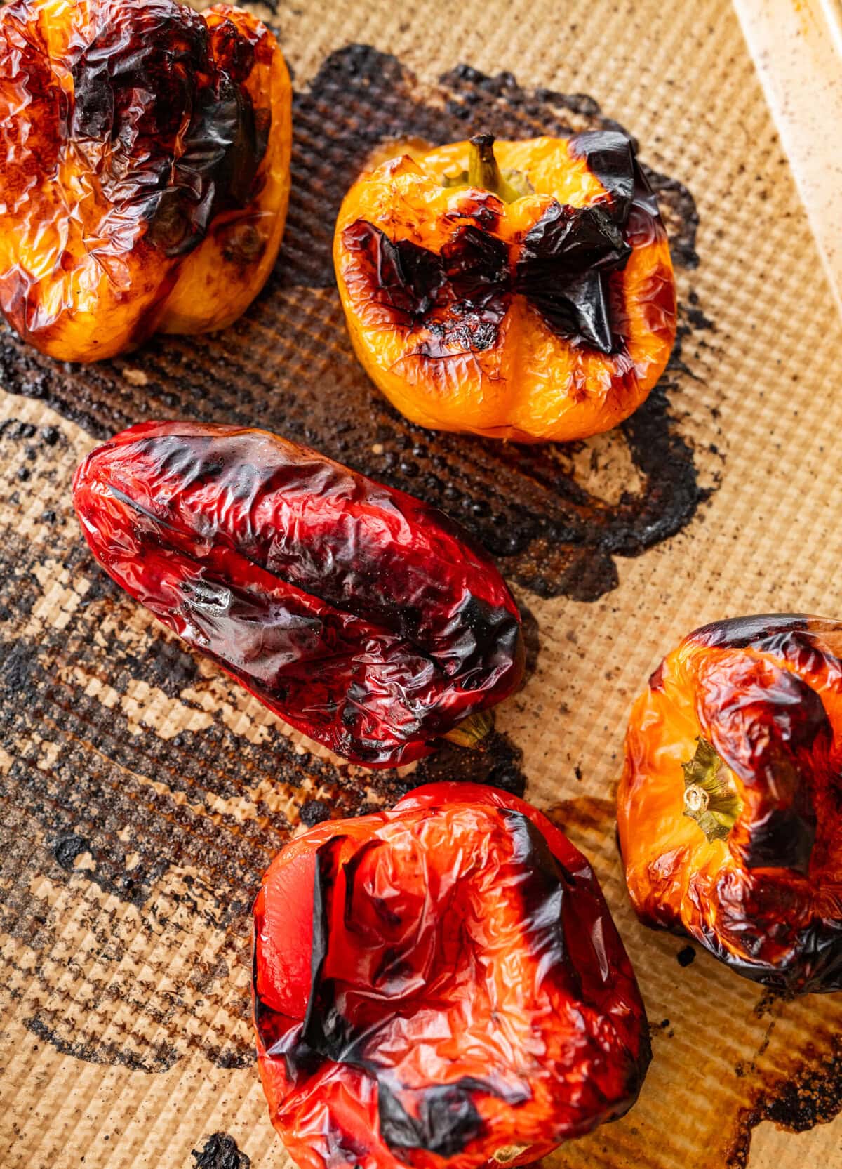 Peppers on a baking sheet after roasting in the oven.
