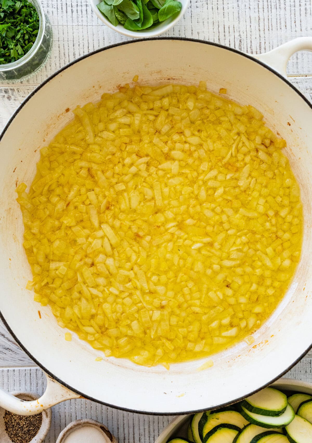 Olive oil and onions in a skillet.