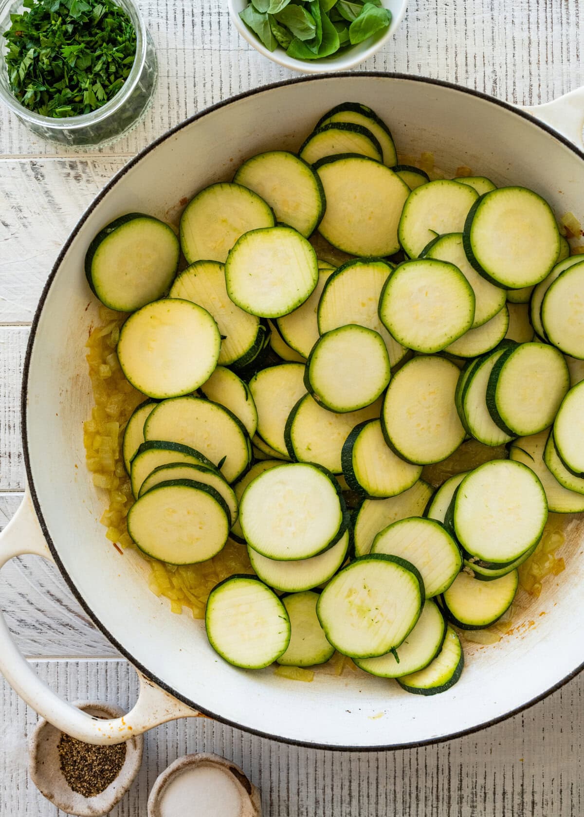 The skillet after adding the zucchini to the onions and olive oil.