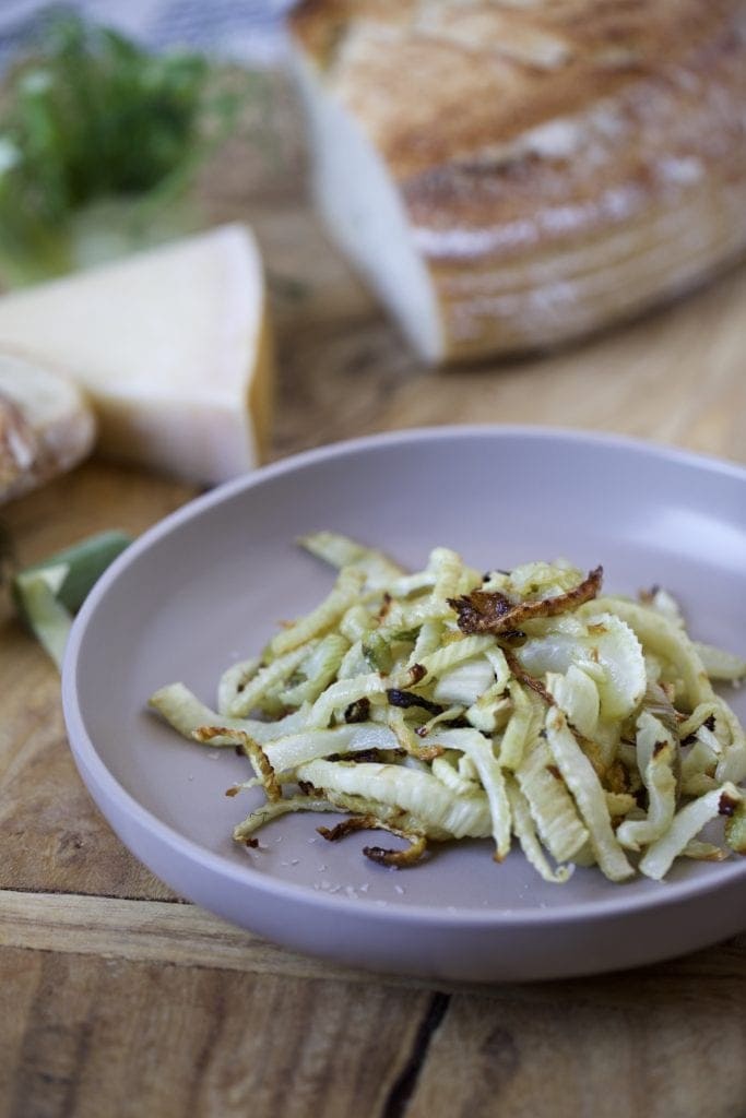 final dish on a plate and a wodden board in the background