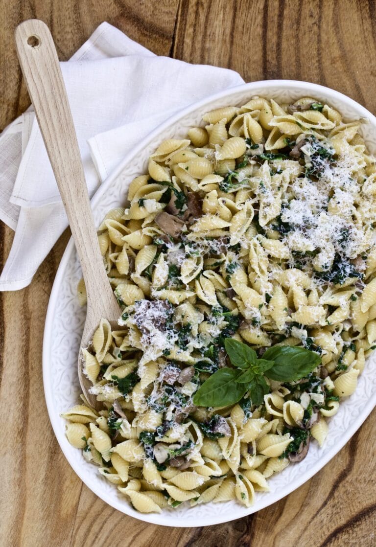 plate of creamy mushroom and spinach pasta shells on serving platter