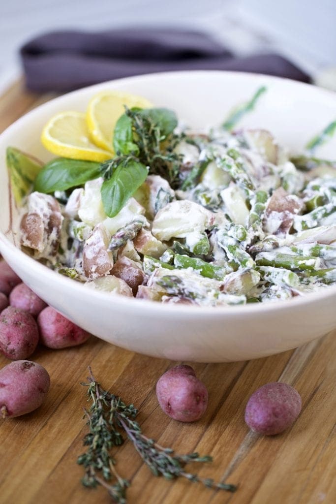 potato salad with lemon and asparagus in a bowl