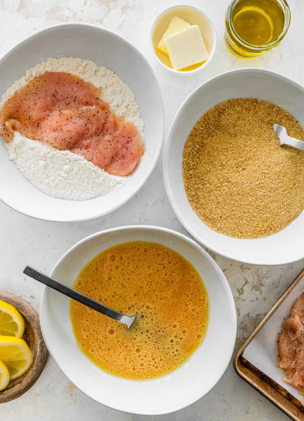dredging station for chicken with flour, egg, and bread crumbs.