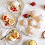 puff pastries filled with cream on a plate with strawberries