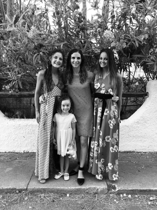 Sardegna home. Three women and one girl standing in a street in Italy, black and white photo