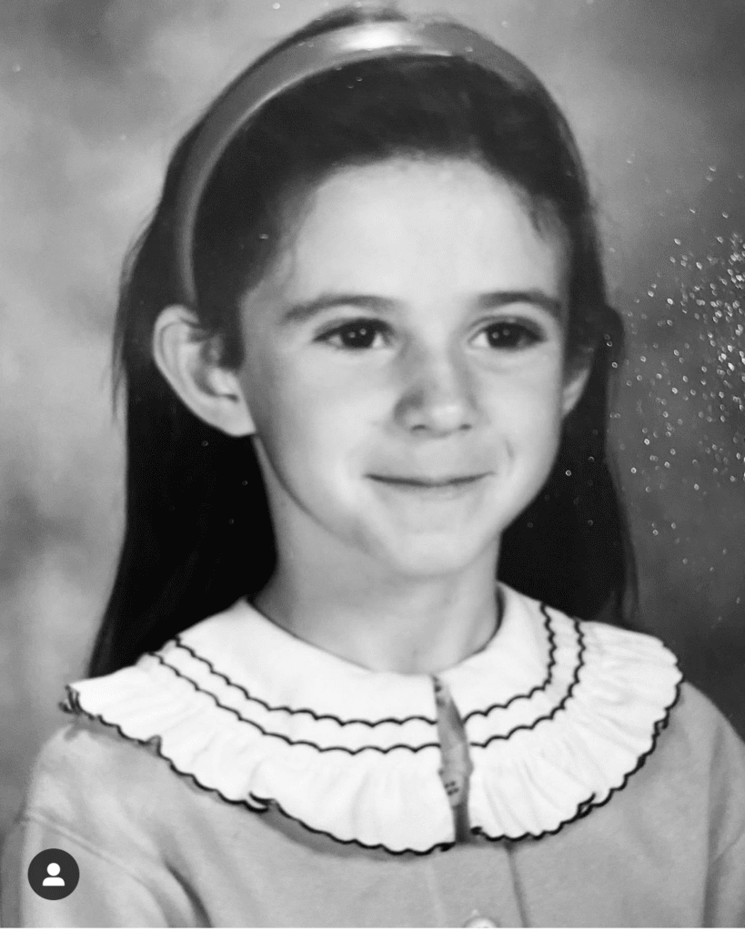Black and white photo of a first grade girl. School photo 