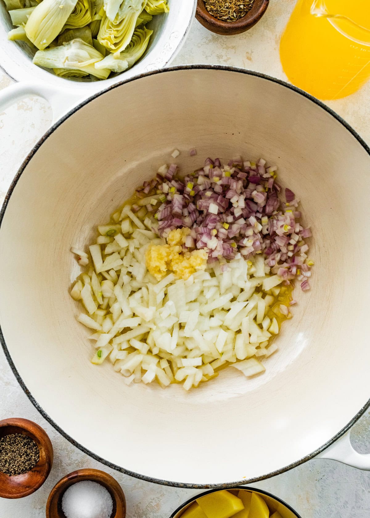 making the artichoke soup-saute the onions and shallots in pot.