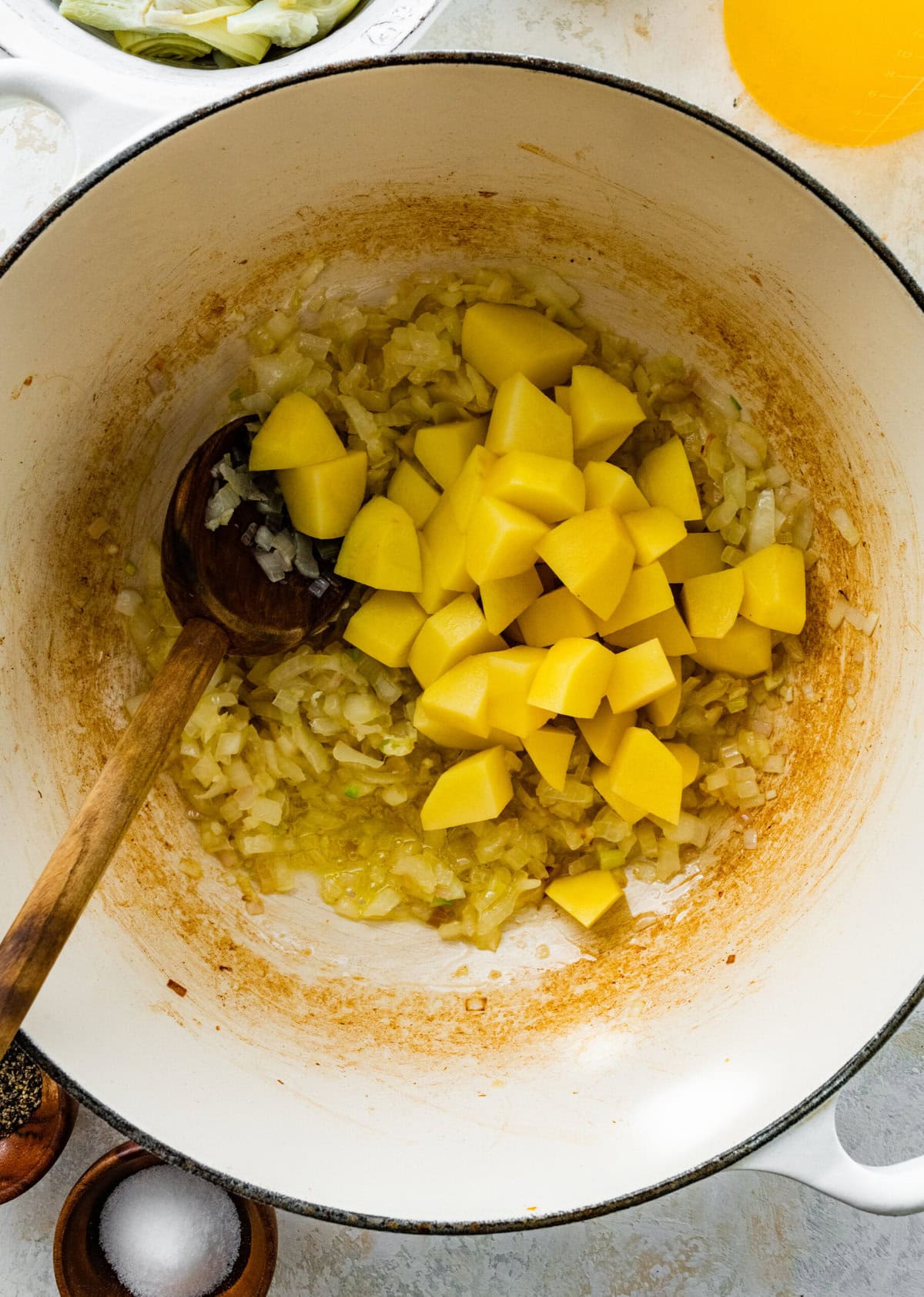making the artichoke soup- add the potatoes to the in pot.
